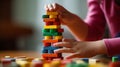 playing with a colorful wooden stacking toy against a plain background
