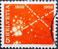 Witzerland - Circa 1952 : a postage stamp printed in the swiss showing a symbol of 100 years of electrical communications in Switz Royalty Free Stock Photo
