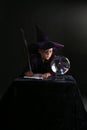 Wizard child consulting crystal ball Royalty Free Stock Photo