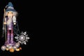 Wizard nutcracker background - Purple figure with snowflake and nuts and Christmas balls, holding a staff with crystal and white o