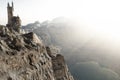 Wizards tower high above the mountains edge overlooking a lake. Fantasy concept 3d rendering illustration.