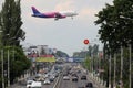 Wizz Air approaching the airport, flying over the road Royalty Free Stock Photo