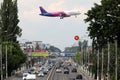 Wizz Air approaching the airport, flying over the road Royalty Free Stock Photo