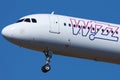 Wizz Air plane flying up in the sky, close-up view Royalty Free Stock Photo