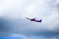 A Wizzair commercial airplane is taking off from the Henri Coanda International Airport.