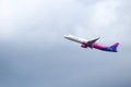 A Wizzair commercial airplane is taking off from the Henri Coanda International Airport.