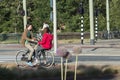 Wo teenagers, one of them mounted on the handlebars of the bicycle