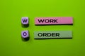 WO - Work Order acronym write on sticky notes isolated on Green background