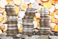Wobbly towers made of diverse old coins, selective focus