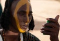 Wodaabe man applies face paint, Gerewol, Niger