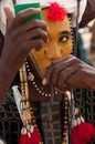 Wodaabe man checking makeup in a mirror, Gerewol, Niger