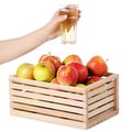 A wodden box of apples a glass of apple juice in hand Royalty Free Stock Photo