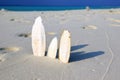 Wodden splitter looking like surfboards standing upright in bright sun on beach, Maldives Royalty Free Stock Photo