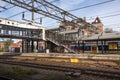 Empty railway station showing platform, bridge and staircase beside tracks