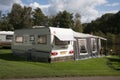 Rear of touring caravan with awning pitched on camping camp site Royalty Free Stock Photo