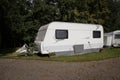 Side of touring caravan with awning pitched on camping camp site Royalty Free Stock Photo