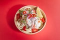 Wok with egg noodles and pork in a creamy sauce. In a food delivery plate. Close-up. view from above. Isolated Royalty Free Stock Photo