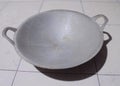 A wok made of aluminum which is usually used for frying fish, side dishes and others