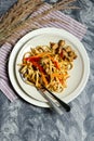 Wok: noodles with chicken and vegetables on a plate with a fork and spoon. View from above Royalty Free Stock Photo