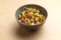 Wok with seafood and greens in a plate on a brown background Royalty Free Stock Photo