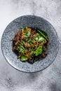 Wok. Soba stir fry noodles with beef and vegetables. Gray background. Top view Royalty Free Stock Photo