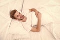 Woke up in good mood. man lye in bed. early morning wake up. man rest white bedroom. cosy weekend at home. time to relax Royalty Free Stock Photo