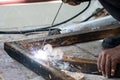 Woker welding steel with sparks lighting