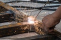 Woker welding steel with sparks lighting