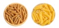 Wolegrain penne pasta from durum wheat in wooden bowl isolated on white background with full depth of field. Top view Royalty Free Stock Photo