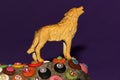 the wolf summons on a colorful stone on a purple background