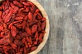 Wolfberries or Goji berries in bowl on wooden table Royalty Free Stock Photo