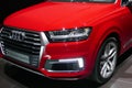 WOLFSBURG, GERMANY - March 22, 2019: Audi Q7 e-tron quattro closeup frontside with lights on and logo in showroom Autostadt Royalty Free Stock Photo