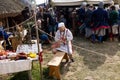 WOLIN, POLAND - AUGUST 6, 2022: XXVII Festival of Slavs and Vikings, woman weaving a traditional medieval cloth belt