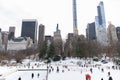 Wollman Ice Skating Rink with People at Central Park in New York City during the Winter with the Midtown Manhattan Skyline Royalty Free Stock Photo