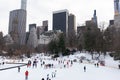 Wollman Ice Skating Rink with People at Central Park in New York City during the Winter with the Midtown Manhattan Skyline Royalty Free Stock Photo