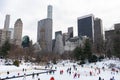 Wollman Ice Skating Rink with People at Central Park in New York City during the Winter with the Midtown Manhattan Skyline Royalty Free Stock Photo