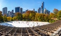 Wollman Skating Rink on a sunny morning in autumn, Central Park South and Midtown Manhattan skyscrapers. New York City Royalty Free Stock Photo