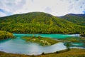 Wolong Bay of Kanas Lake. Crystal blue river, small sandbar.Green tree hills Royalty Free Stock Photo