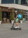 Wolt courier at work on electric scooter in Bratislava. Food delivery service