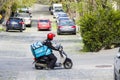 Wolt delivery courier in the street with scooter and box