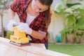 Womam Carpenter working with wood electrical sanding machine Royalty Free Stock Photo