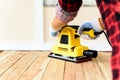 Woman working with wood electrical sanding machine Royalty Free Stock Photo