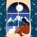 A woman a girl sits by the window with a cat and looks at the winter mountain landscape. Lonely evening waiting.