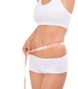Woman, abdomen and tape in studio for health, measuring and fitness for weight loss. Female person, results on progress Royalty Free Stock Photo