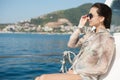 Woman aboard a boat looking at the sea