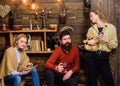 Woman absorbed by interesting book and not noticing her family. Girl with teddy bear in retro outfit standing next to Royalty Free Stock Photo