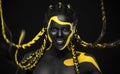 Woman on abstract poster with gold face art. Yellow and black colors of body paint. Young girl with bodypaint. An Royalty Free Stock Photo