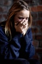 Woman, abuse and crying with hands, scared and alone with fear, hiding and afraid. Toxic relationship, shame or home for