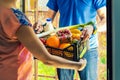 Woman accepting groceries box from delivery man Royalty Free Stock Photo