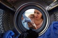 Woman Accidentally Dyeing Laundry Inside Washing Machine Royalty Free Stock Photo